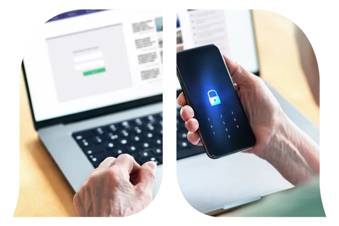 An elderly person holding a phone with a lock icon in front of a computer in the background.