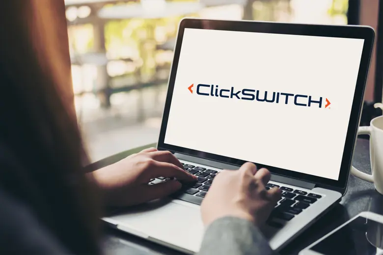 A laptop displaying ClickSWITCH logo.