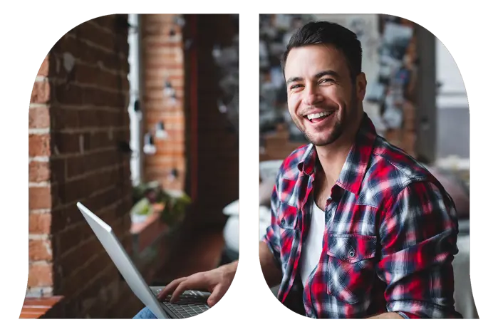 A man on his laptop smiling.
