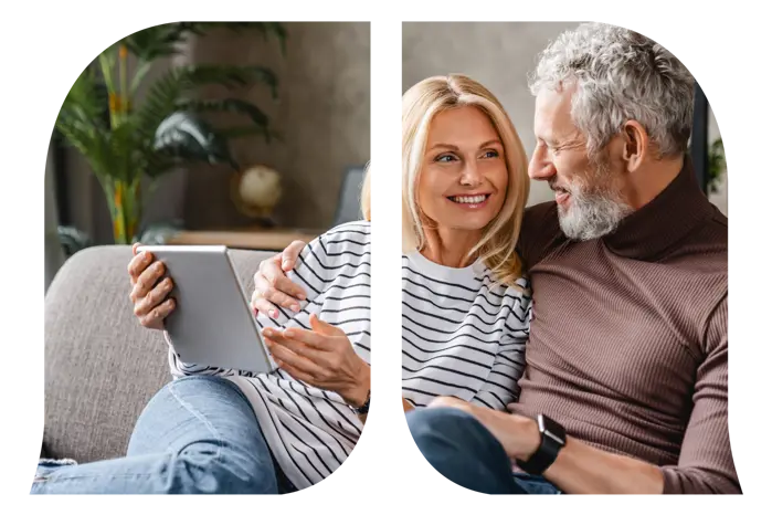 A couple looking at one another while the woman is holding her tablet.
