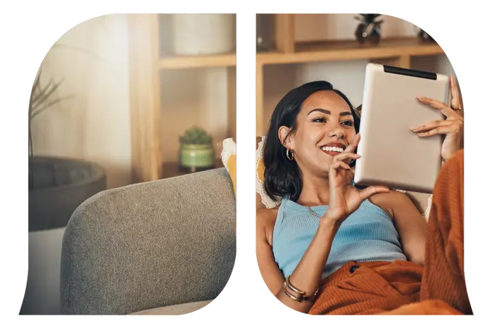 A woman lying on the couch using her tablet.